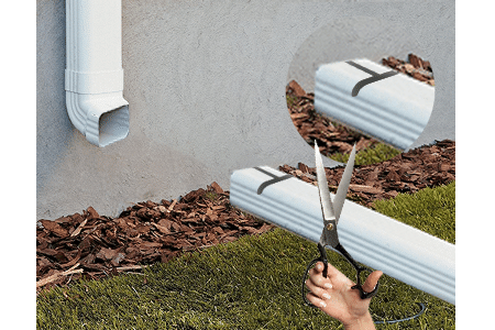 Cutting  out gutter to make  DIY hinged downspout extension