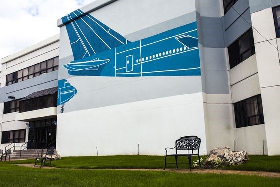 Airplane garden wall mural using a stencil