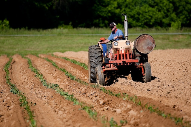 Man driving a DIY garden tractor